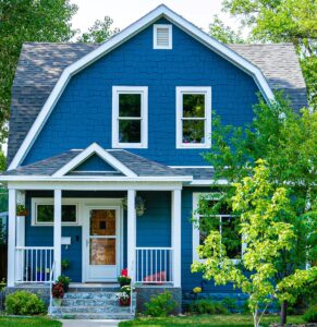 What First Time Denver Home Buyers Need to Know to Buy Their Dream Home Image of Blue Home with White Trim