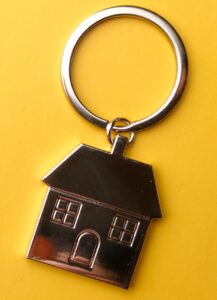 Need for a down payment in Denver - picture of house keychain with yellow background