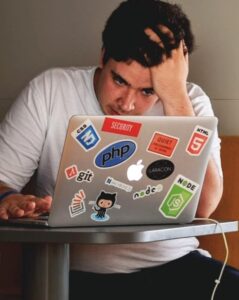 Buy a home in Denver with bad credit - image of someone stressed in front of a laptop